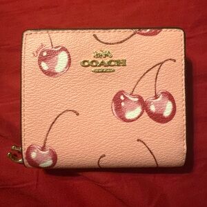 Coach snap wallet with cherry print.